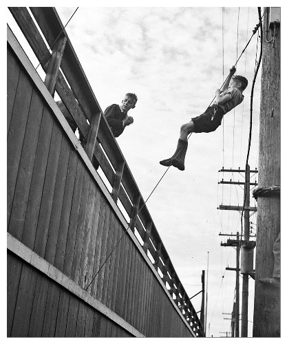 George Hunter Photography Two boys sneaking into a baseball game. Winnipeg Manitoba Canada 1944