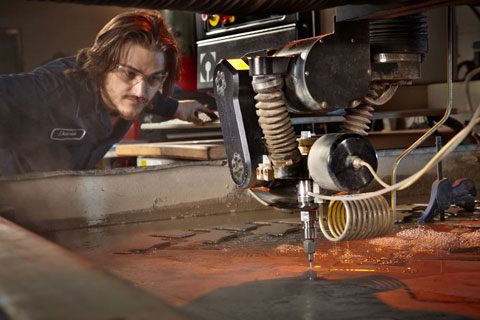 Machine operator industrial photographer cutting metal