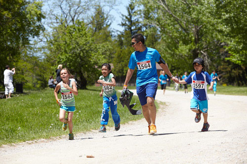 Event Photography of family running to finish at Tim Hortons Run/Walk