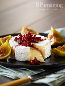 Appetizer photography Baked Castello Brie with Figs and Pomegranate Reduction