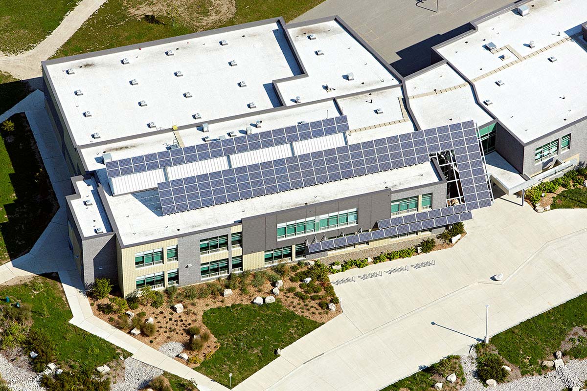 Helicopter view of solar panel roofing on building