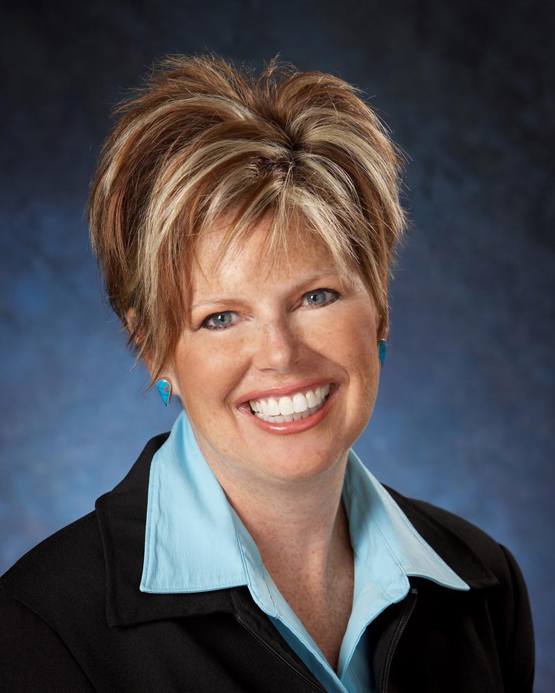 Business Portrait Photographer of businesswoman and dentist on blue background