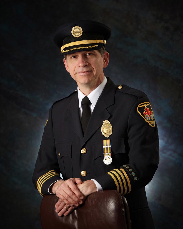 Business Portrait Photography of ambulance chief hamilton on dark blue background