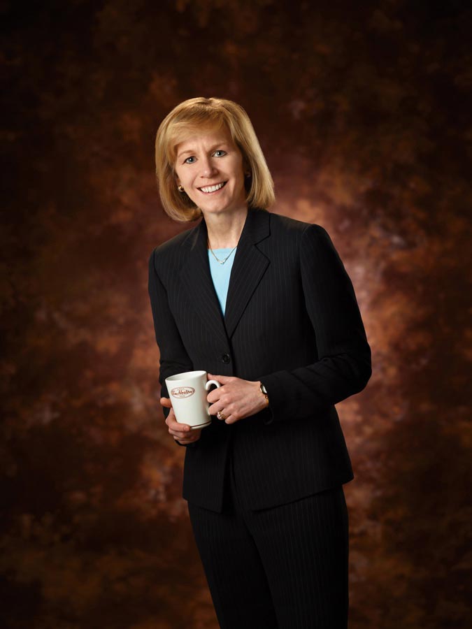 Full Body Portrait Photography of Tim Hortons businesswoman on brown background