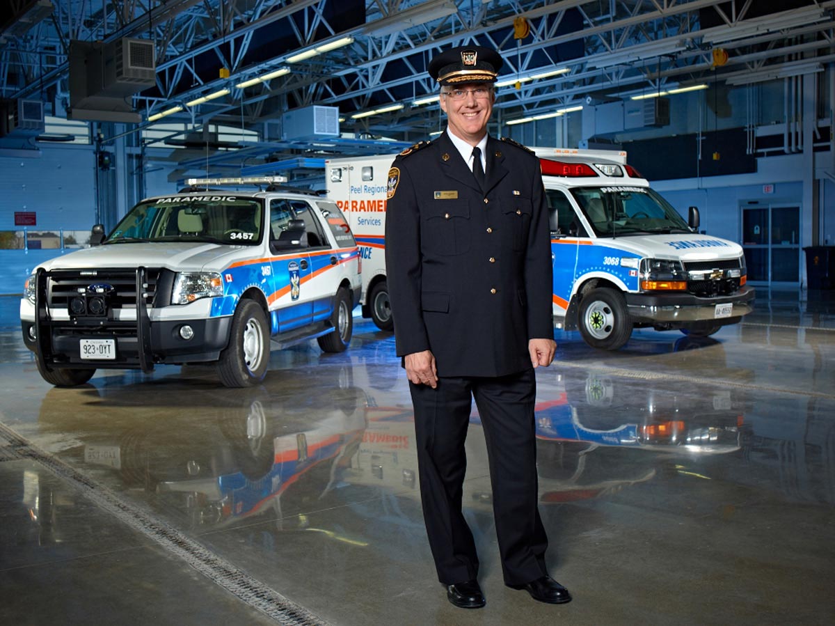 Environmental Portrait Photography of Ambulance captain with vehicles in background