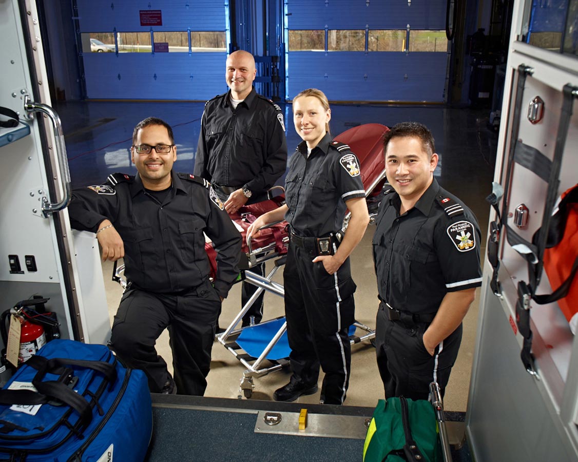 Group Portrait Photography Paramedic team outside vehicle