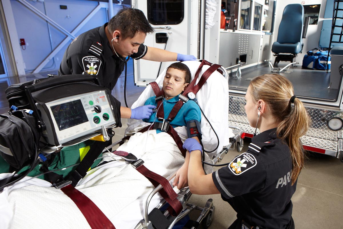 Lifestyle Paramedic Photographer helping child on stretcher