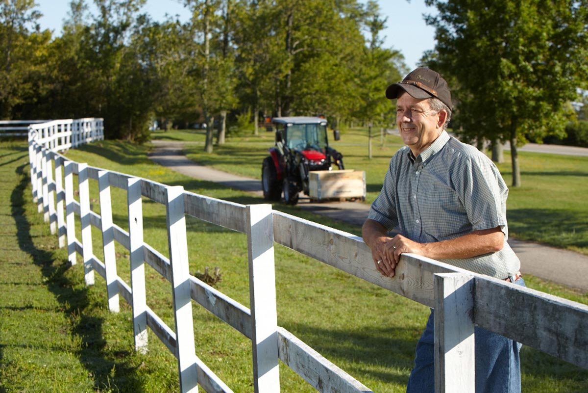 Lifestyle Farm Photographer farm worker looking into field