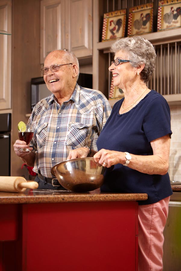 Lifestyle Senior Photography of retirement home couple cooking dinner