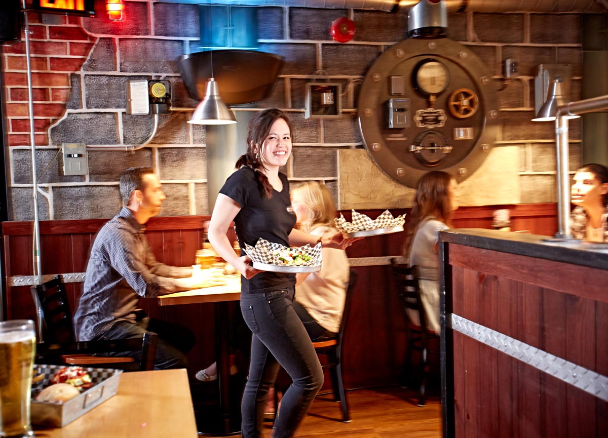 Lifestyle Server Photography of The Works restaurant waitress serving burgers