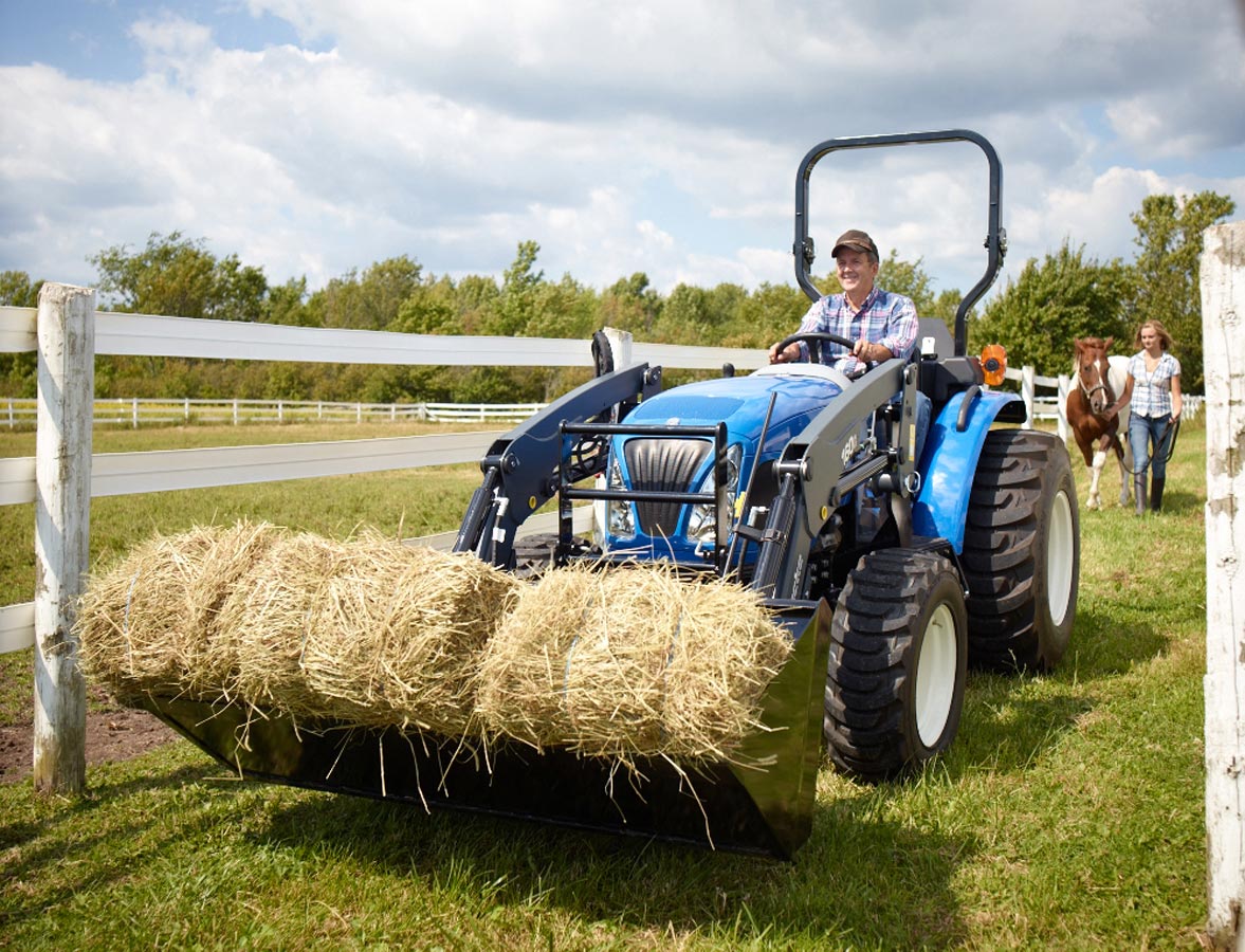 Lifestyle Farmer Photography of farmer driving tractor with horse hay to field