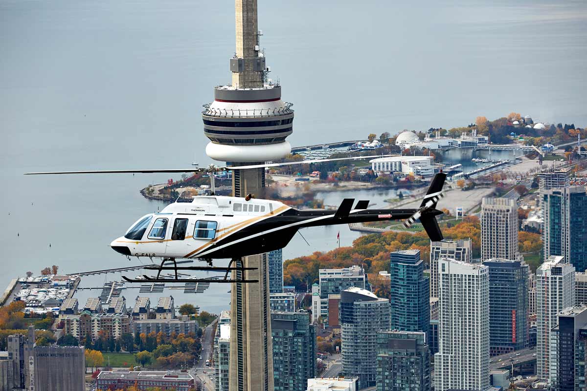 Aerial photography of flying helicopter in downtown Toronto and Lake Ontario