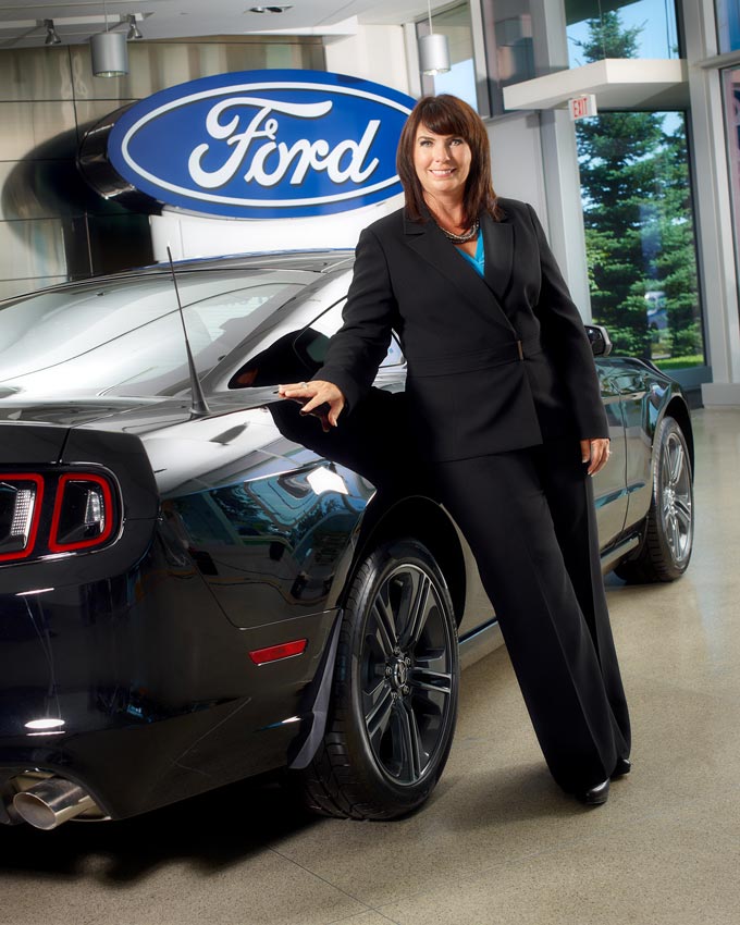Portrait photography of Ford employee beside Mustang