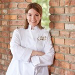 Portrait photography of Chef Carla with brick background