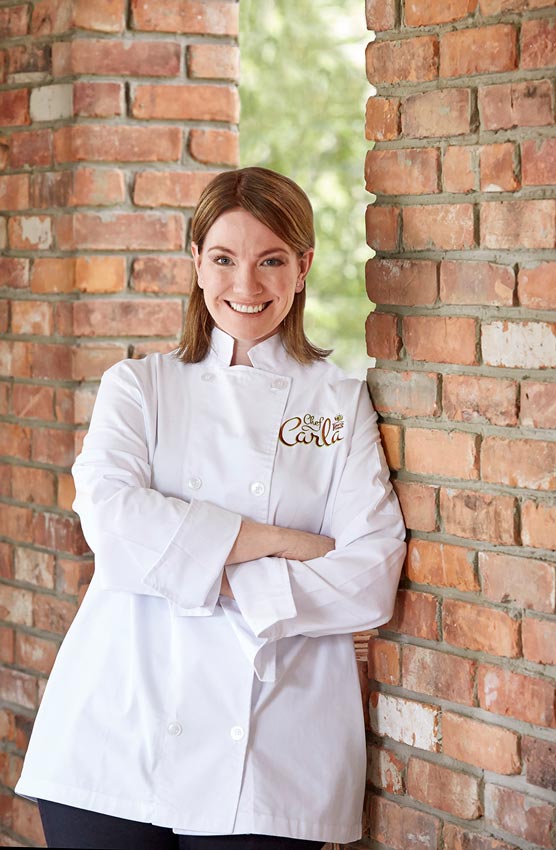 Portrait photography of Chef Carla with brick background