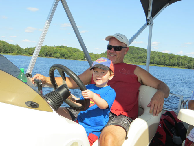 Spencer Driving Boat in Huntsville Ontario lake