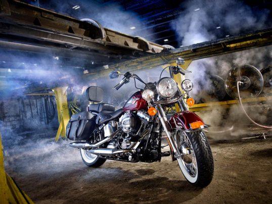 Illustrative Photo - Harley Davidson Red Motorcycle Black Saddle Bags Industrial Setting